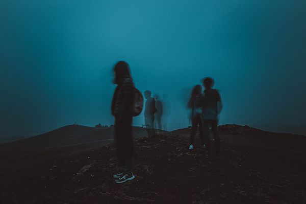 Teens standing in blue haze